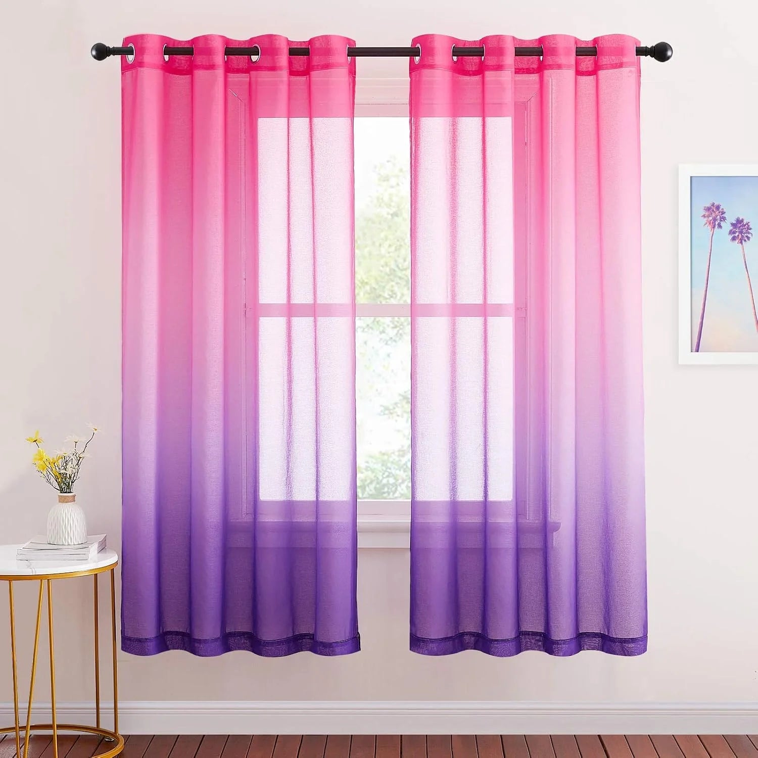 Pink to purple ombre sheer curtains with grommet top on a bedroom window