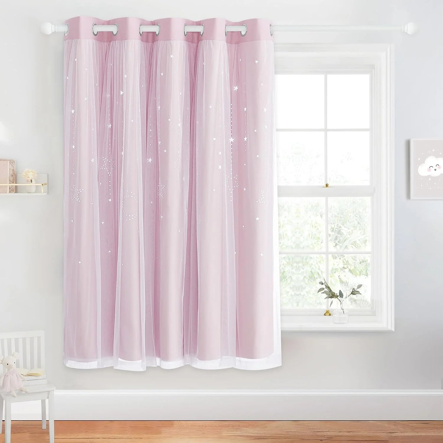 Pink sheer curtain with silver star pattern and grommet top in a bright kids room