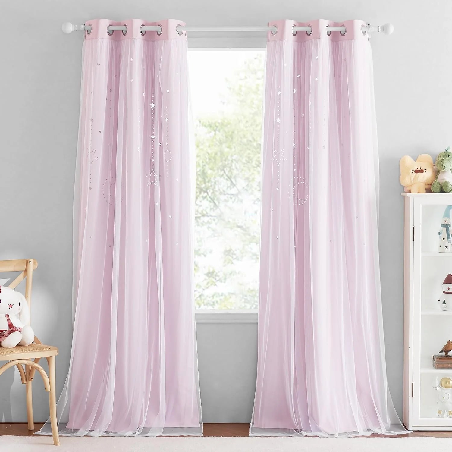 Soft pink sheer star-print curtains with grommet top in a bright kids bedroom