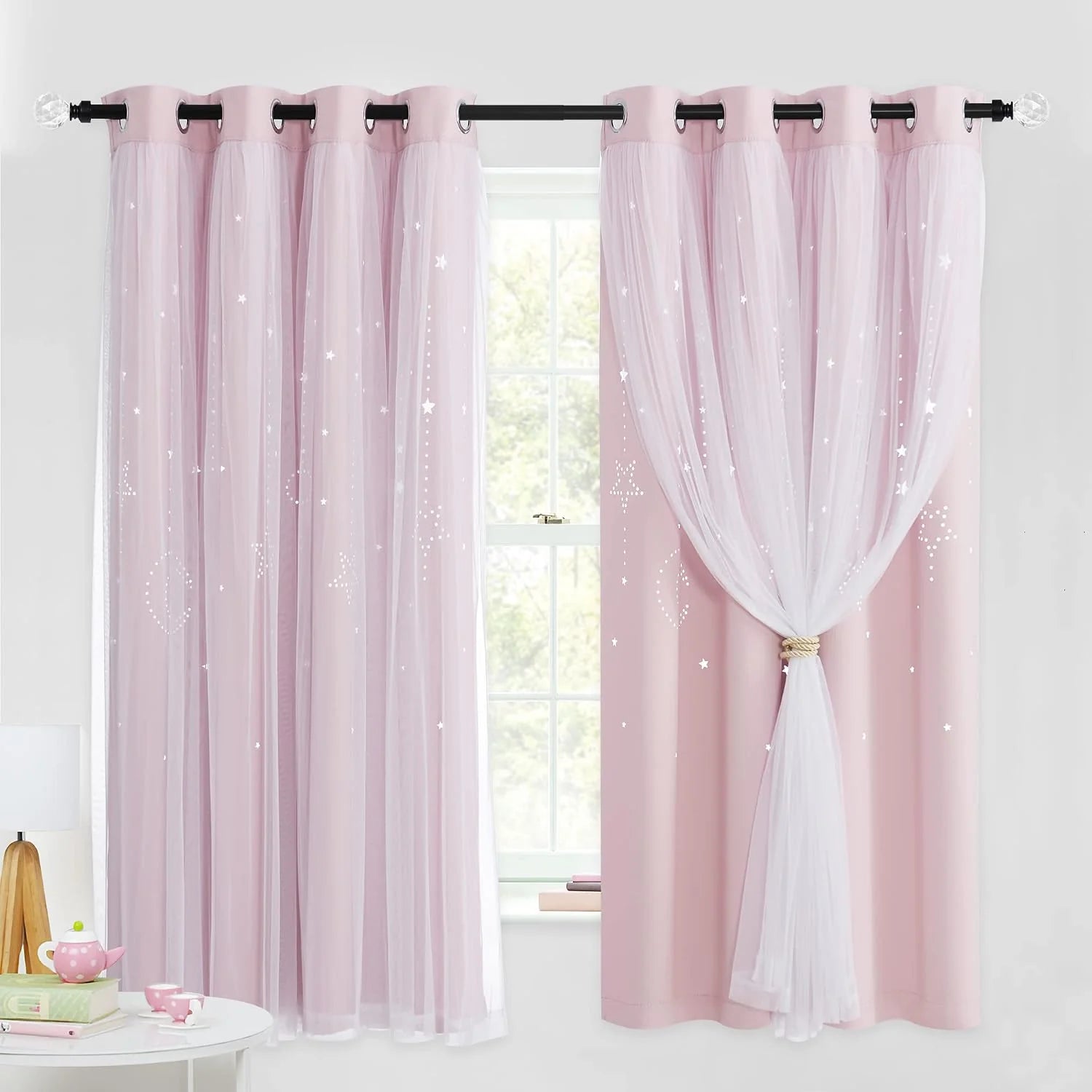 Pink kids curtains with sheer overlay, star pattern, and grommet top by window