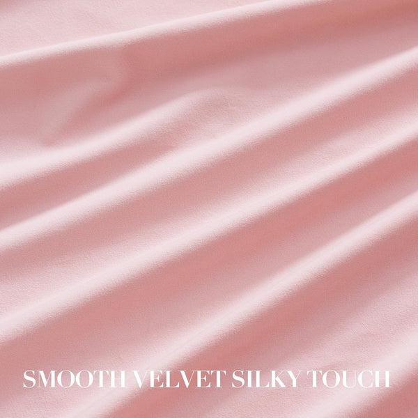Close-up of soft blush pink velvet fabric with smooth, silky texture and elegant folds.