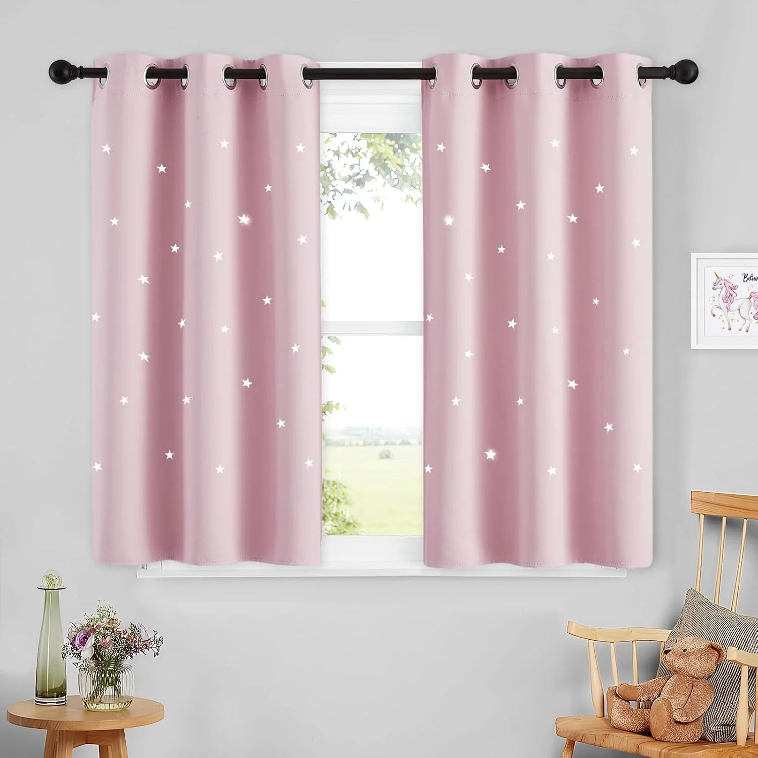 Soft pink star blackout curtains with silver grommets in a cozy kids bedroom