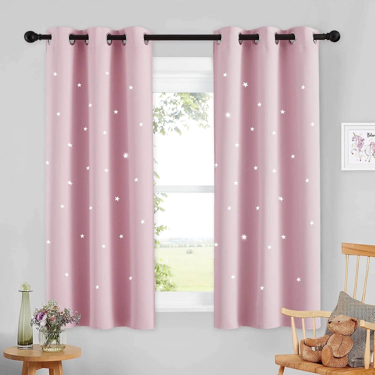 Pink kids room curtains with star cutout details and silver grommet top