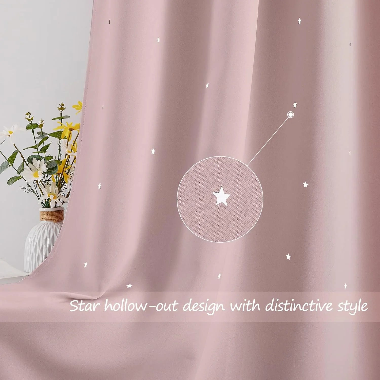 Soft pink curtain with tiny star cutout details draped beside a white vase of flowers
