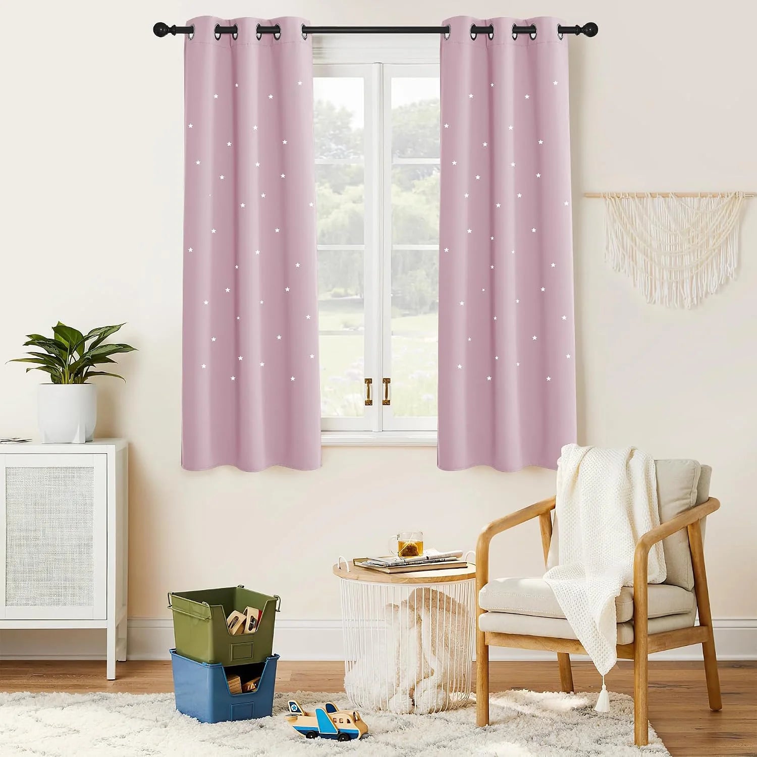 Soft pink star-pattern grommet curtains hanging in a cozy kids room window