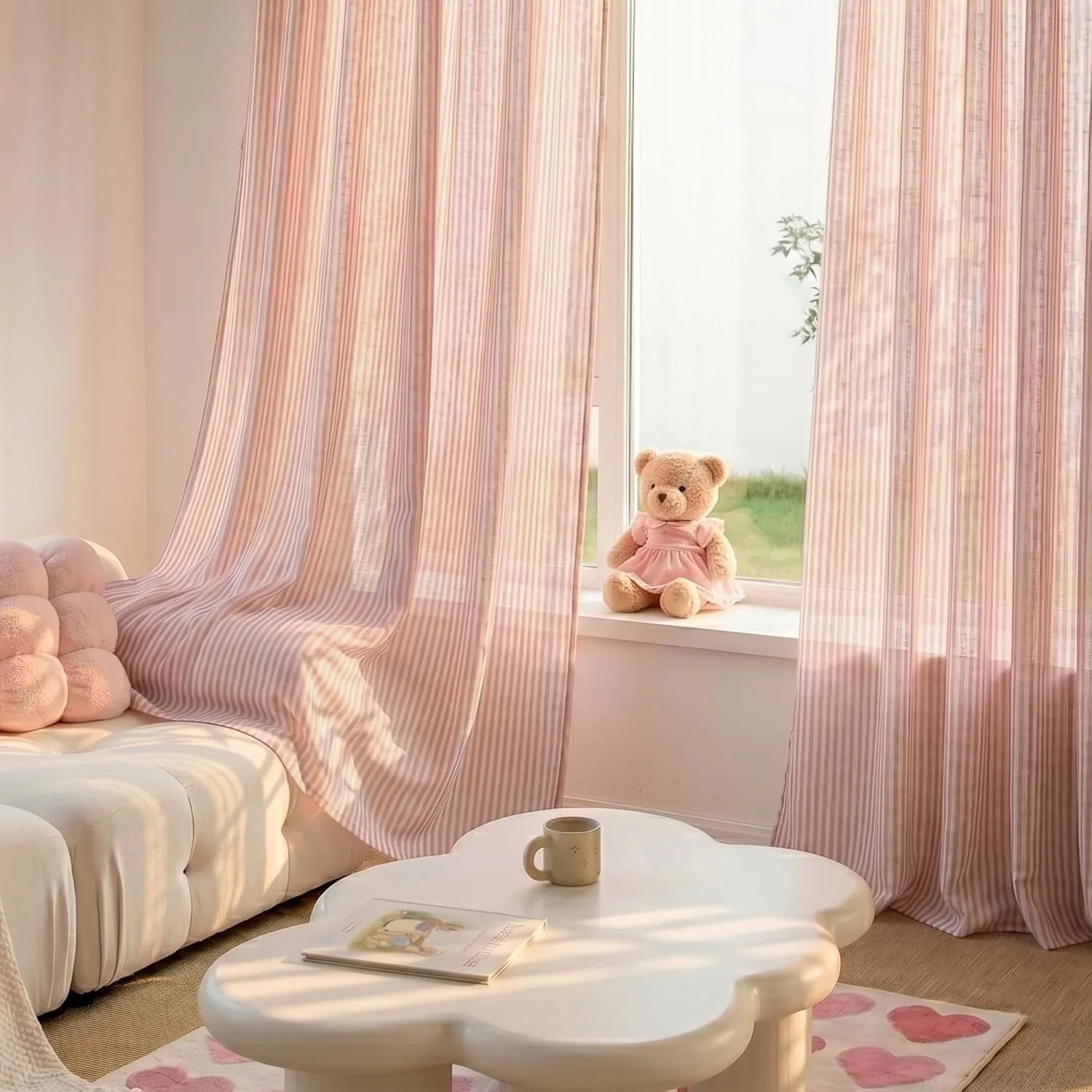 Sheer pink and white striped curtains in a sunny, playful room with a teddy bear on the windowsill.