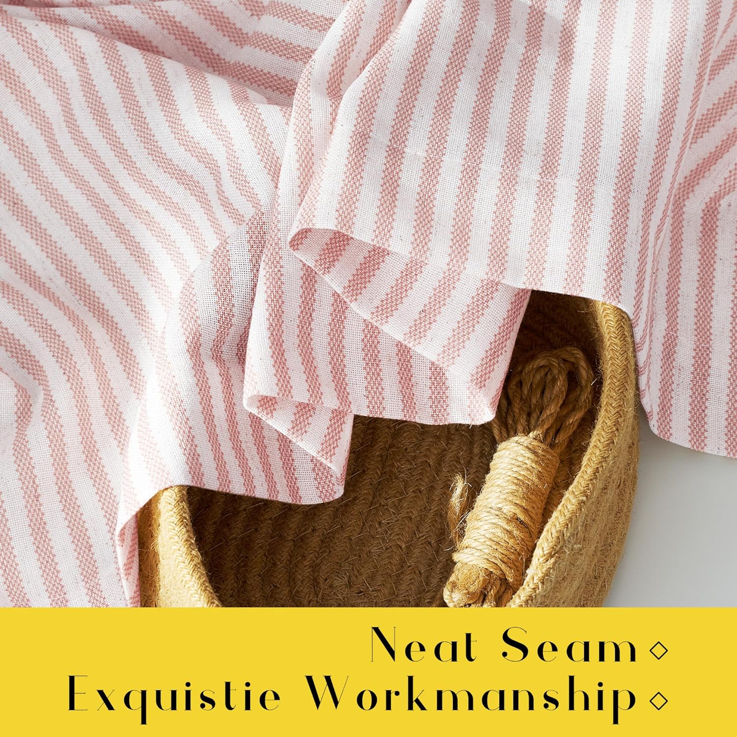 Pink and white vertically striped textured woven cotton throw draped over a natural fiber basket.