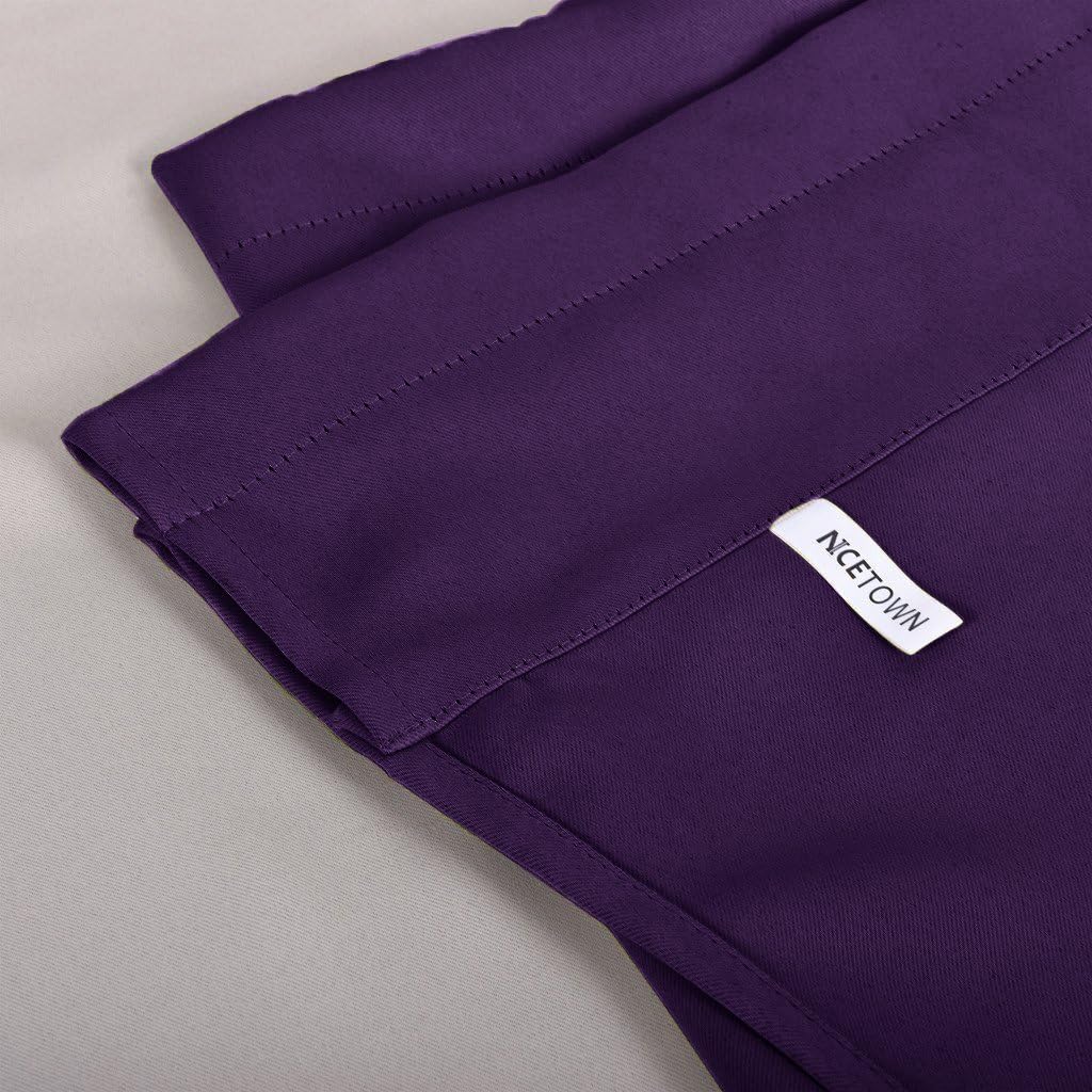 Close-up of a folded plum-purple solid curtain panel. Features smooth fabric, stitched hem, and 'NCETOWN' brand tag.
