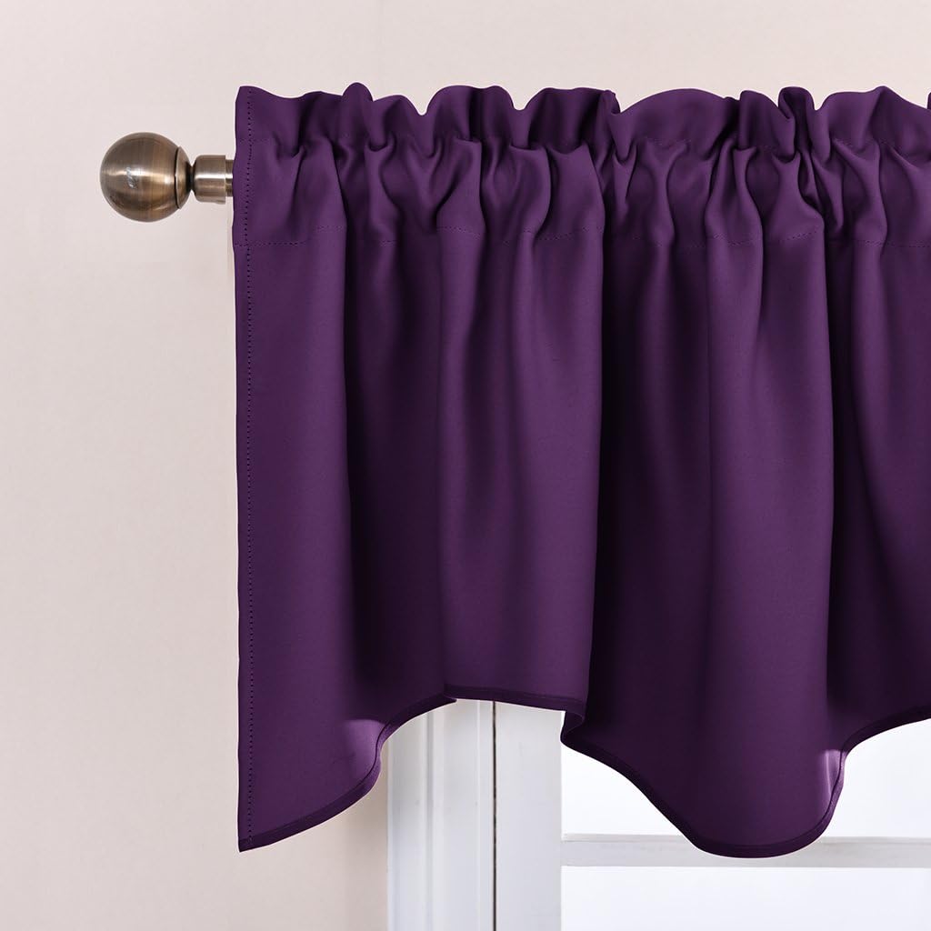 Deep plum rod pocket valance curtain with a scalloped hem hangs from a bronze finial rod over a window.
