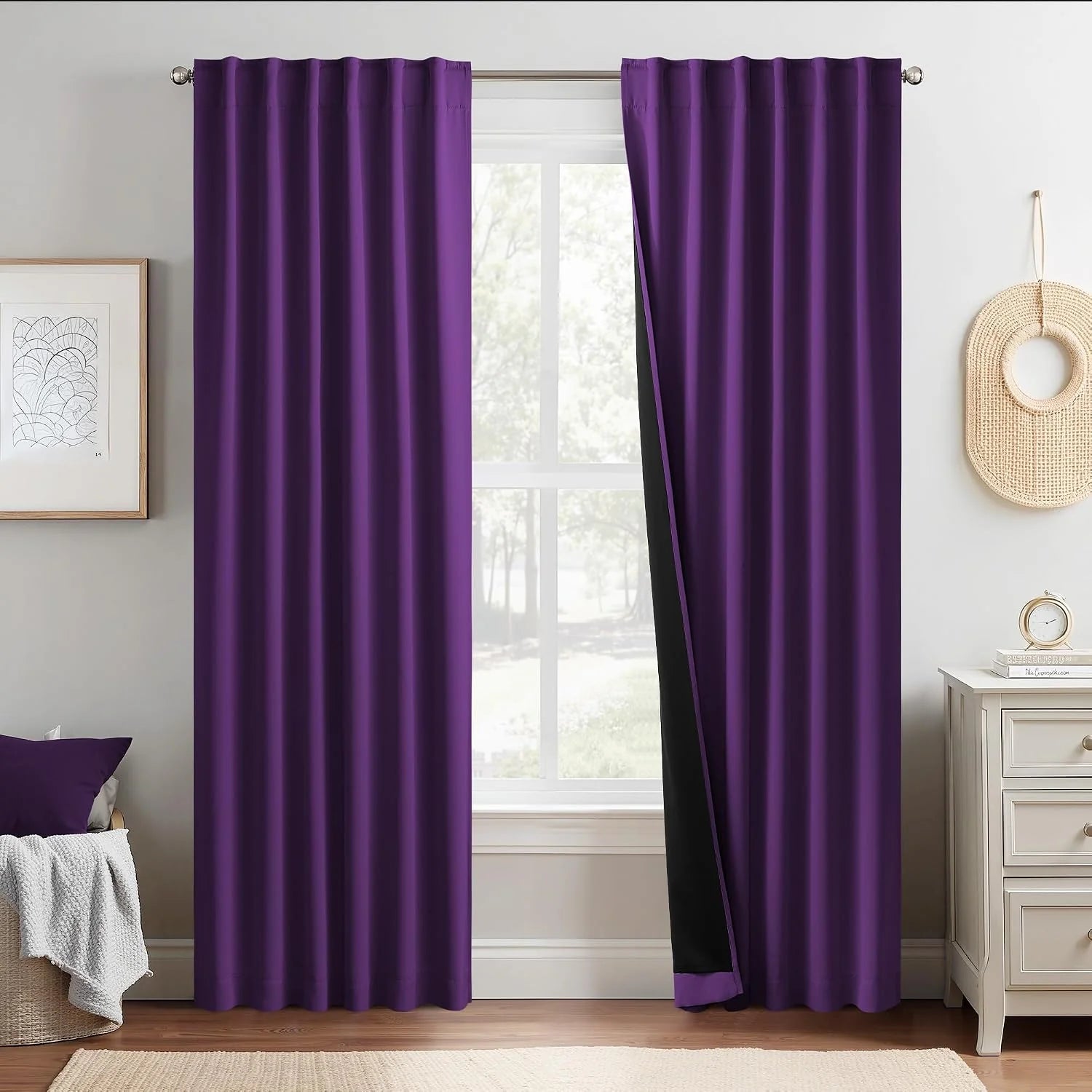 Purple blackout curtains with rod pocket top hanging in a bright modern bedroom