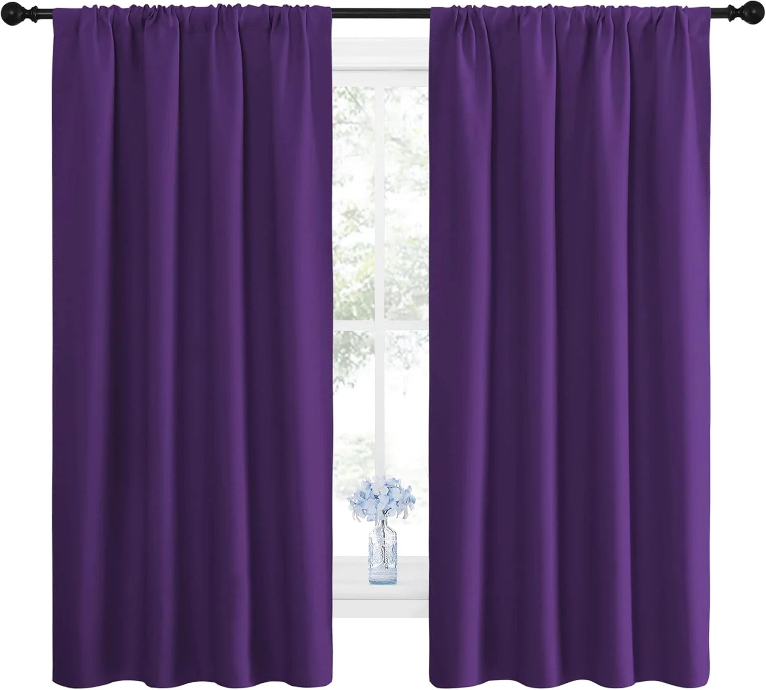 Vibrant purple rod pocket blackout curtains on a black rod, framing a window with a vase.