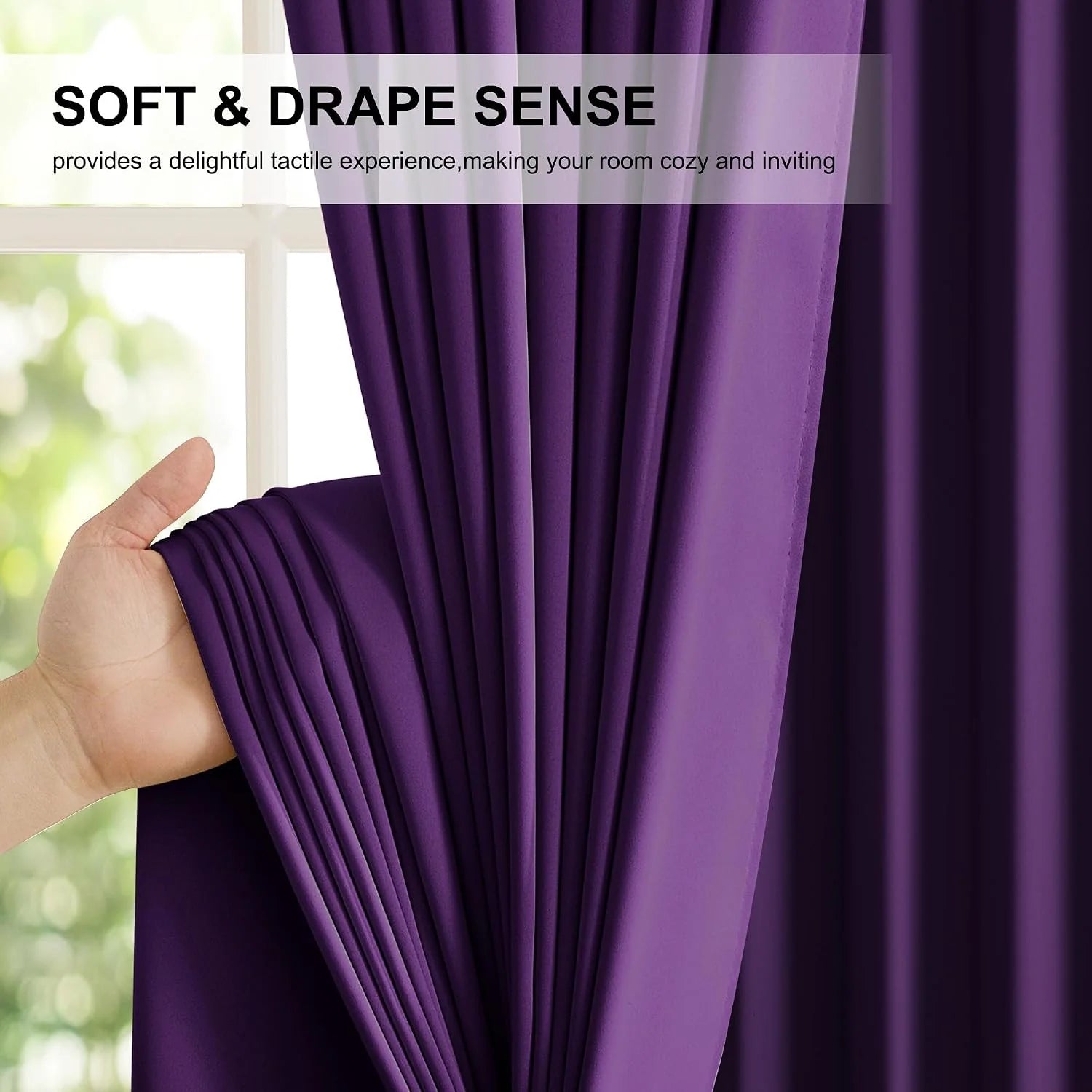 Hand holding a rich purple curtain panel to show its soft drape and smooth texture