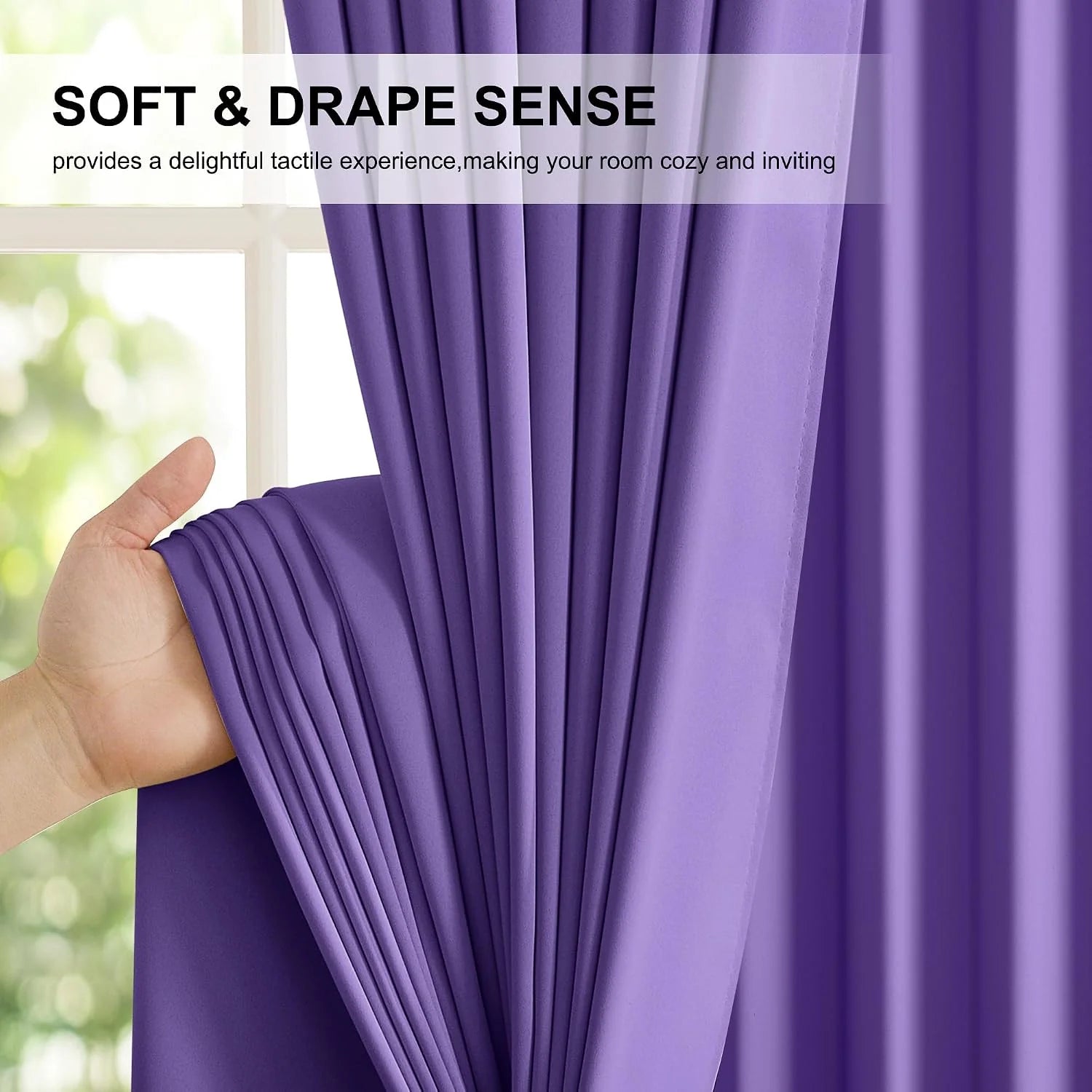 Hand holding a purple curtain panel to show its soft drape and smooth fabric texture
