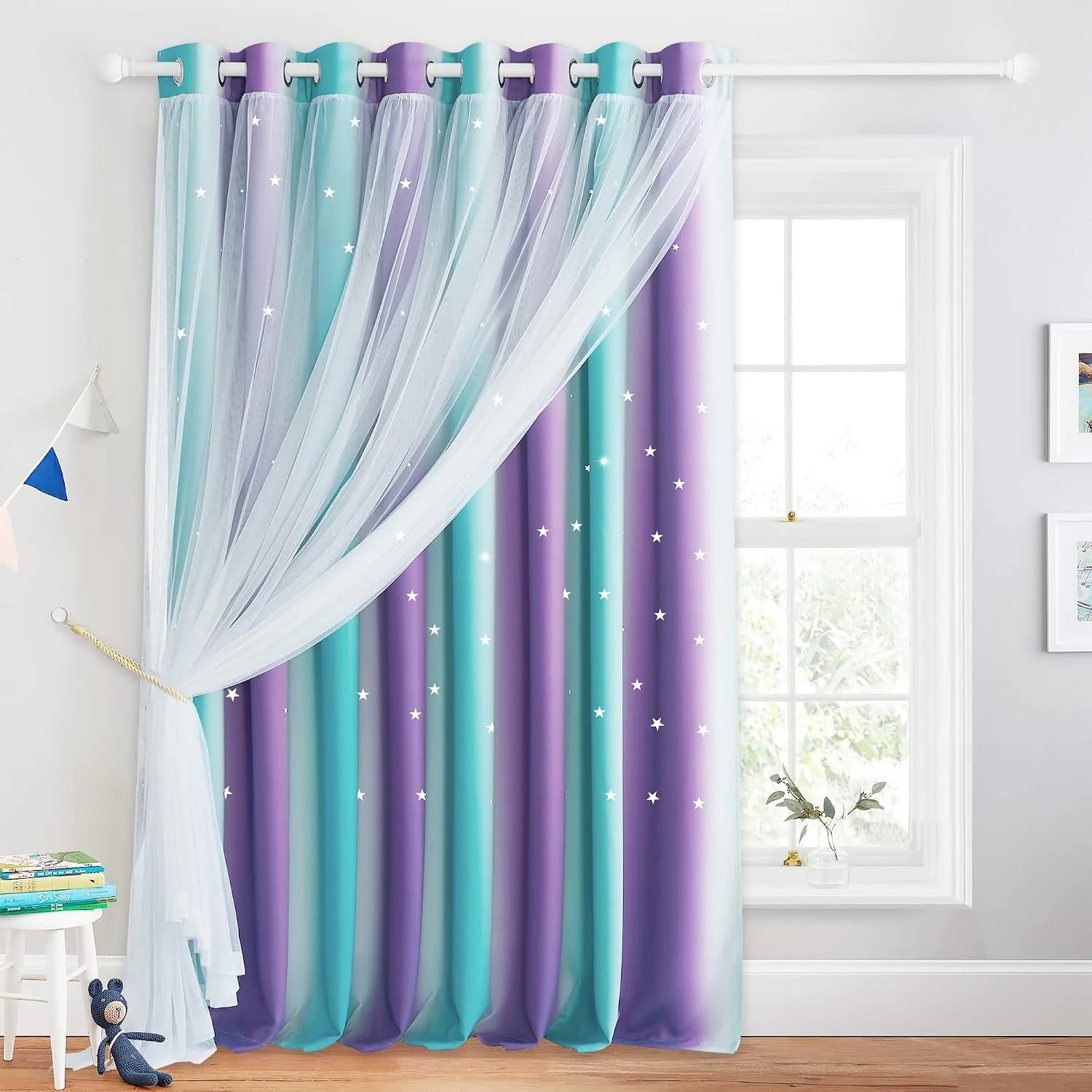 Purple and teal star curtains with sheer white overlay in a bright kids room