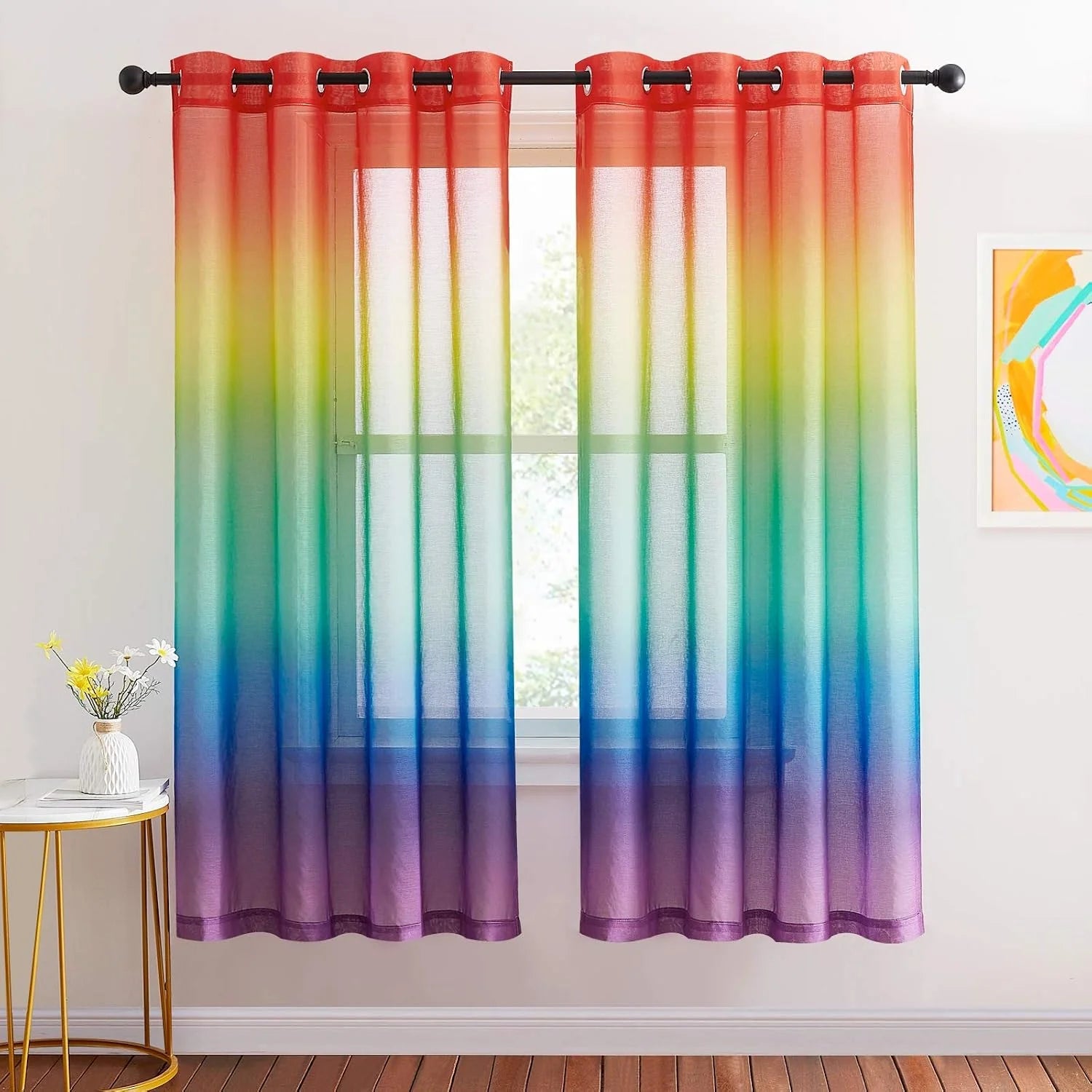 Rainbow ombre sheer curtains with grommet top hanging in a bright modern room