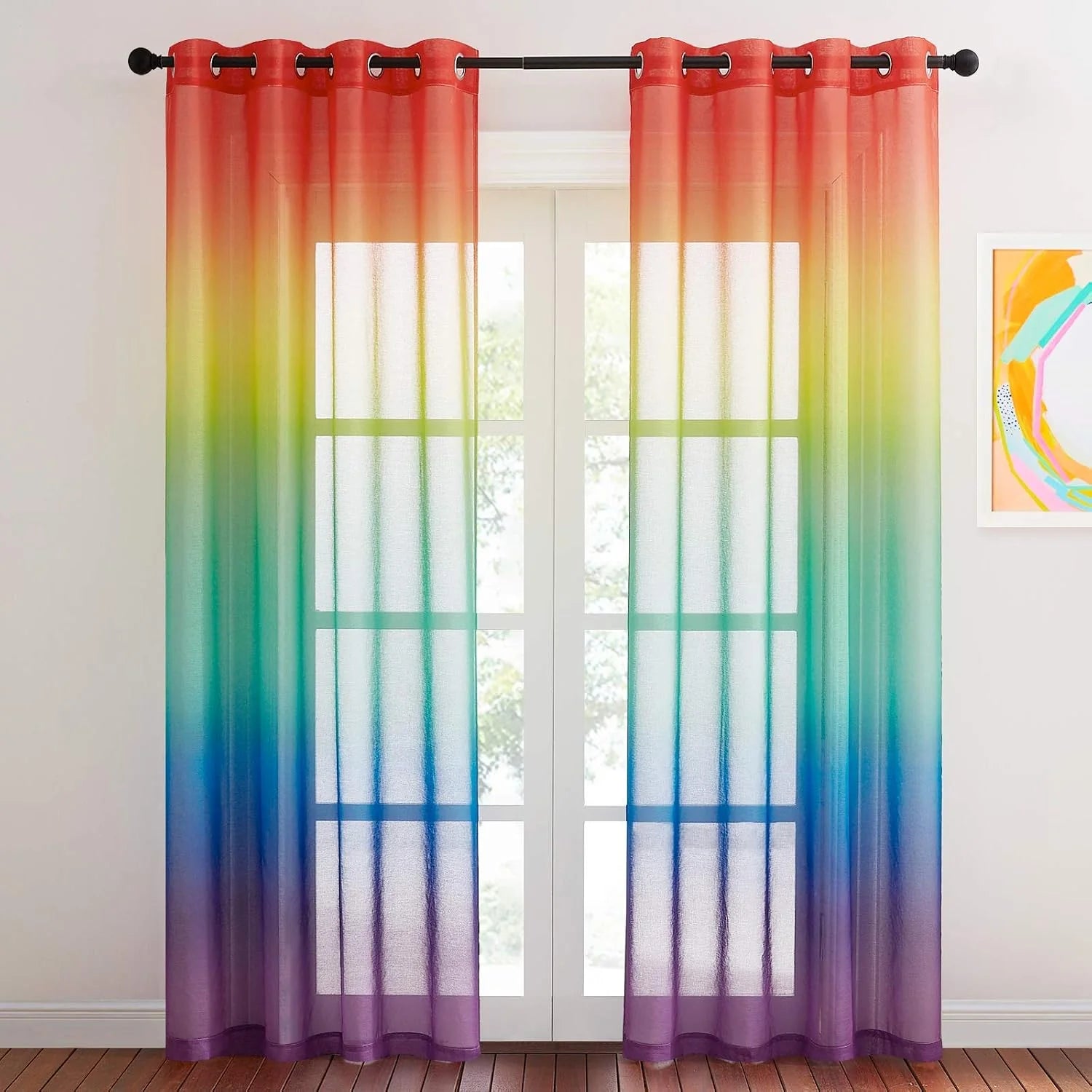 Rainbow ombre sheer curtains with black grommets hanging over white French doors