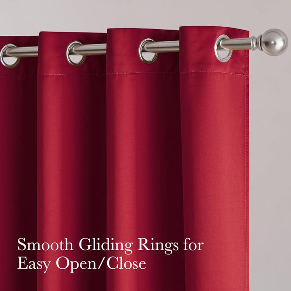 Vibrant deep red grommet top curtain panel hangs on a silver rod, showing smooth fabric and easy gliding rings.
