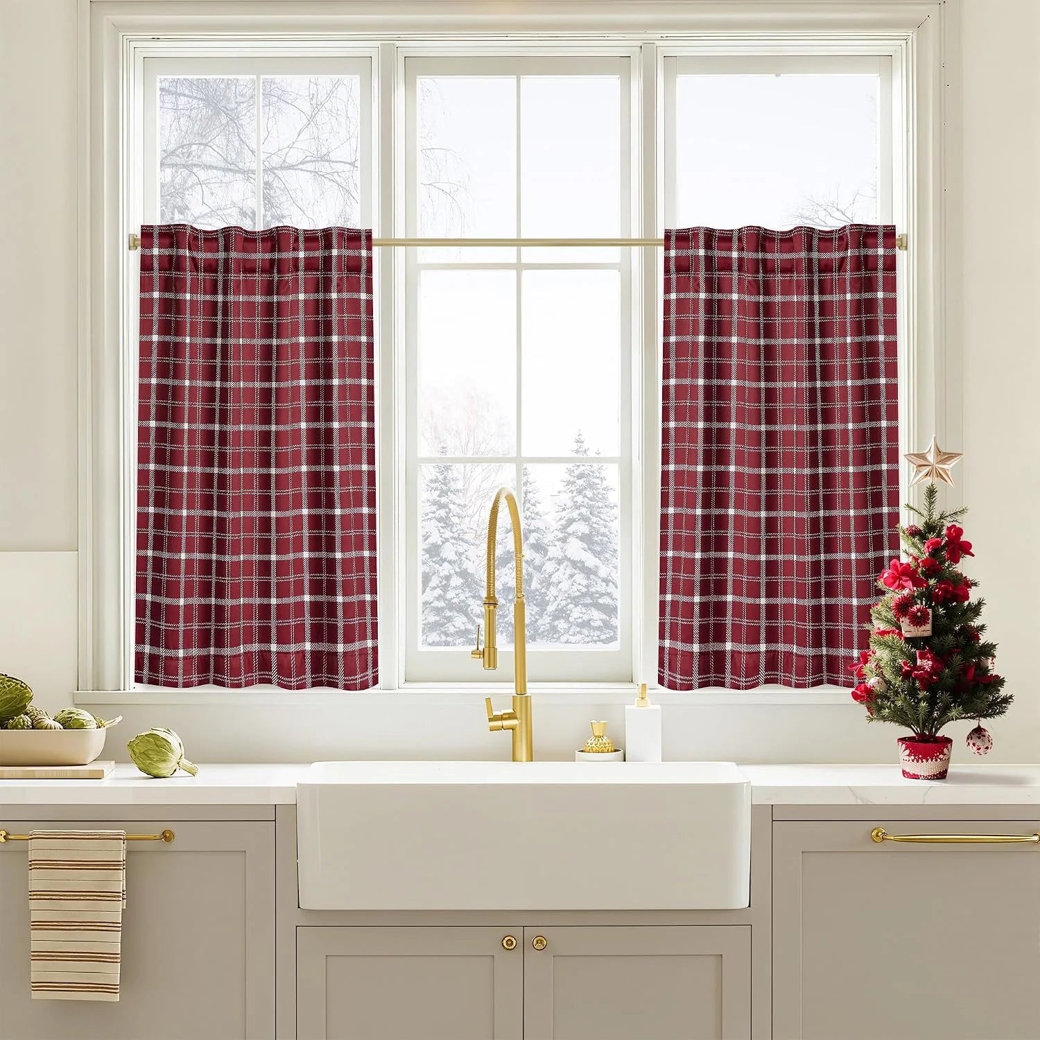 Red plaid cafe curtains on a white kitchen window above a farmhouse sink