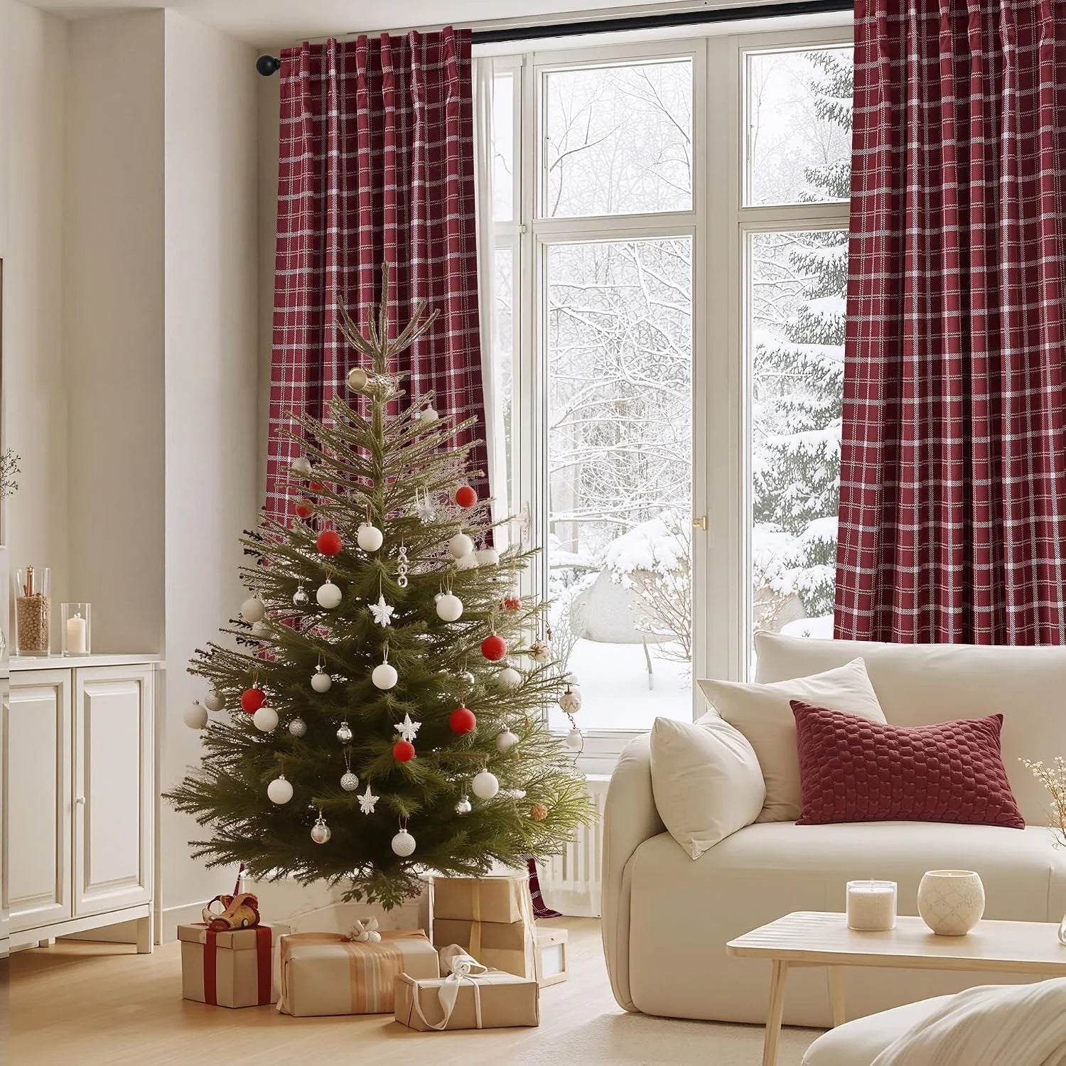Red plaid curtains framing a snowy window in a cozy living room with Christmas tree