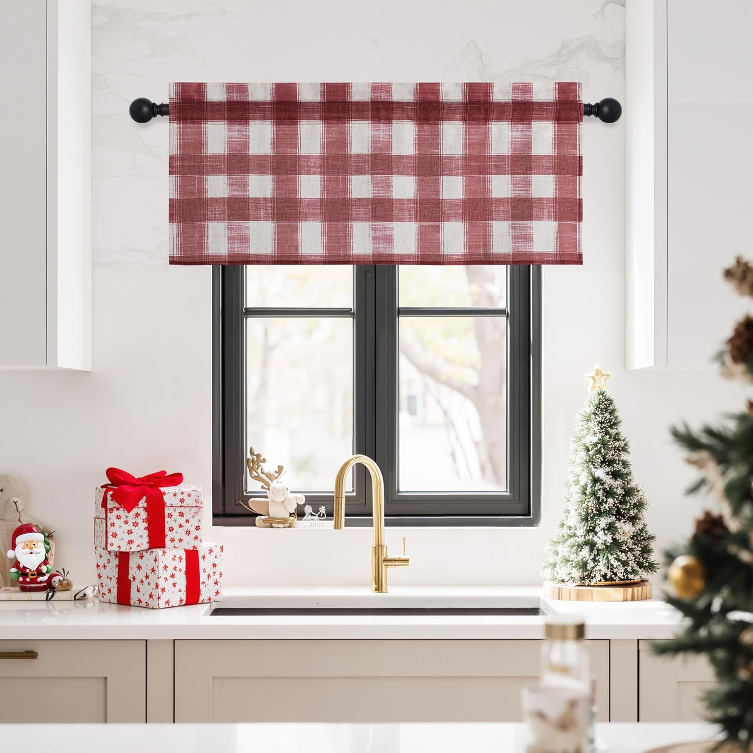 Red and white buffalo check fabric window valance on a black curtain rod in a bright kitchen setting.