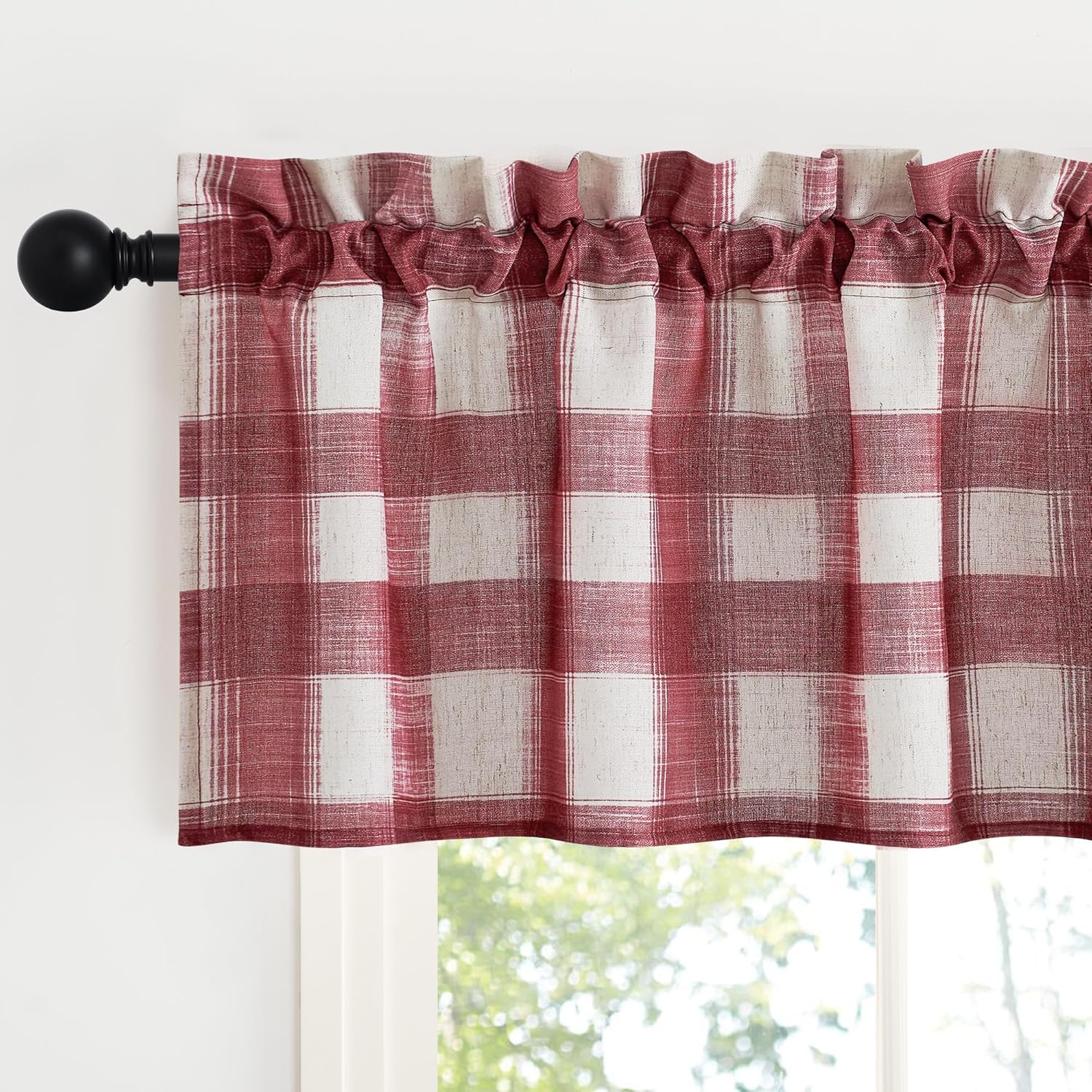 Red and white buffalo plaid valance with rod pocket top, hanging on a black curtain rod above a window.
