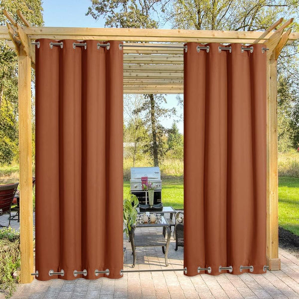 Rust brown outdoor curtains with silver grommets hanging from wooden pergola, shading patio.