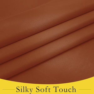Close-up of rust brown silky soft fabric, highlighting its smooth texture and natural folds.
