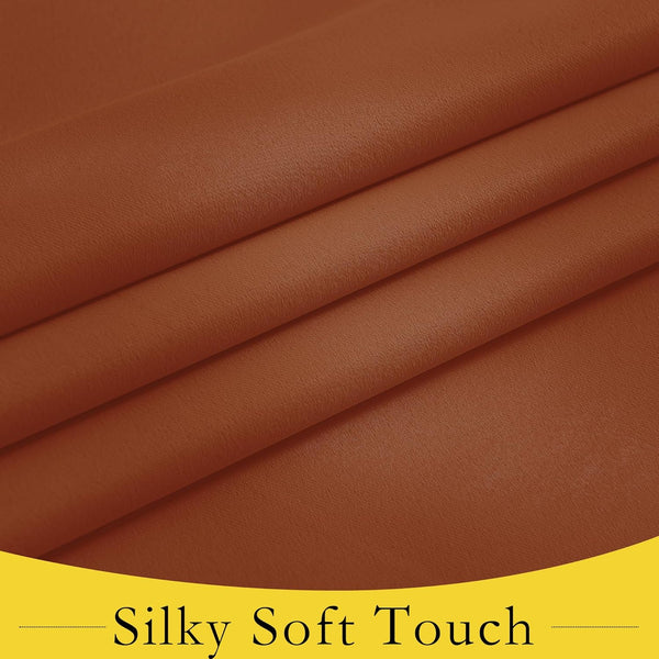 Close-up of rust brown silky soft fabric, highlighting its smooth texture and natural folds.