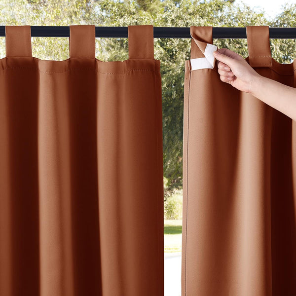 Rust brown outdoor curtains featuring hook-and-loop tab tops. A hand shows the fastener.