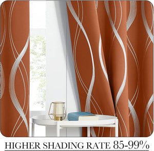 Rust orange blackout curtains with elegant silver wavy lines hung by a bright window.