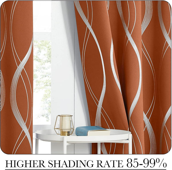 Rust orange blackout curtains with elegant silver wavy lines hung by a bright window.