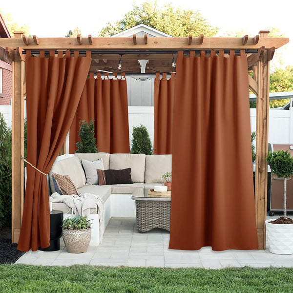 Rust tab top outdoor curtains offering privacy and shade on a wooden pergola over a patio seating area.