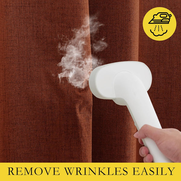 Handheld steamer removing wrinkles from a rust-colored woven curtain, demonstrating easy fabric care.