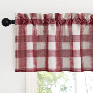 Rustic red and off-white plaid window valance with a rod pocket top, gathered on a black curtain rod above a window.