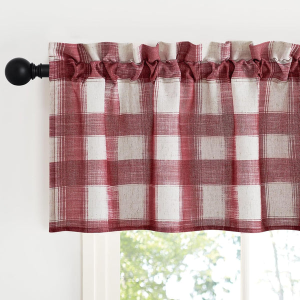 Rustic red and off-white plaid window valance with a rod pocket top, gathered on a black curtain rod above a window.