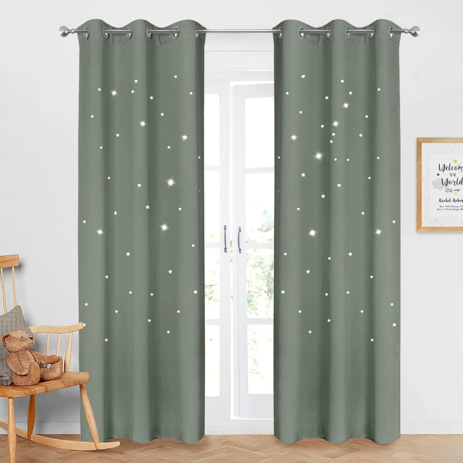 Sage green blackout curtains with star cutouts and silver grommets in a nursery