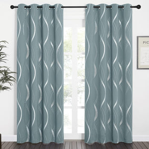 Sage blue grommet top curtains featuring silver metallic wavy lines, hanging on a dark rod.