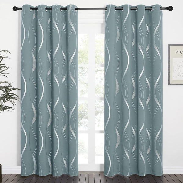 Sage blue grommet top curtains featuring silver metallic wavy lines, hanging on a dark rod.