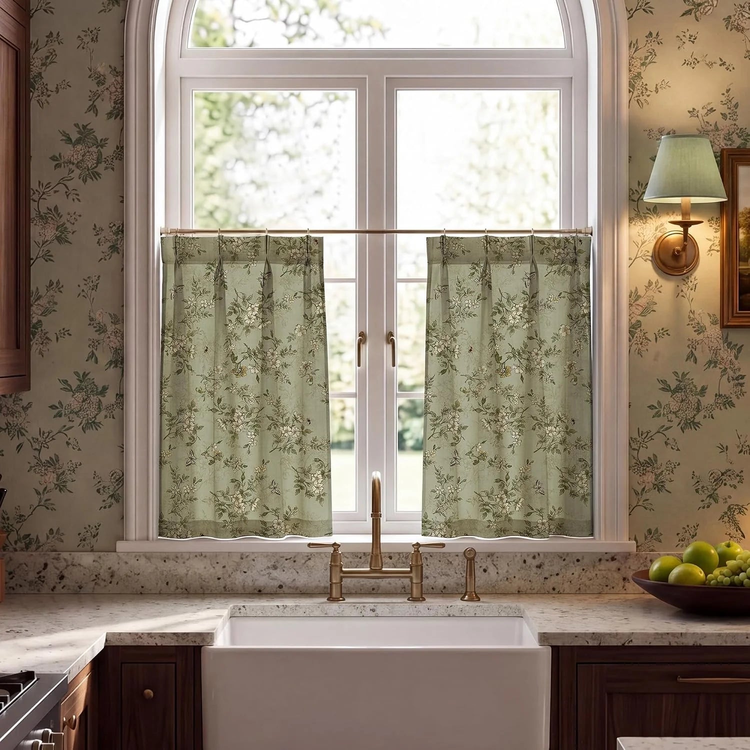 Sage green floral cafe curtains on an arched kitchen window above a farmhouse sink
