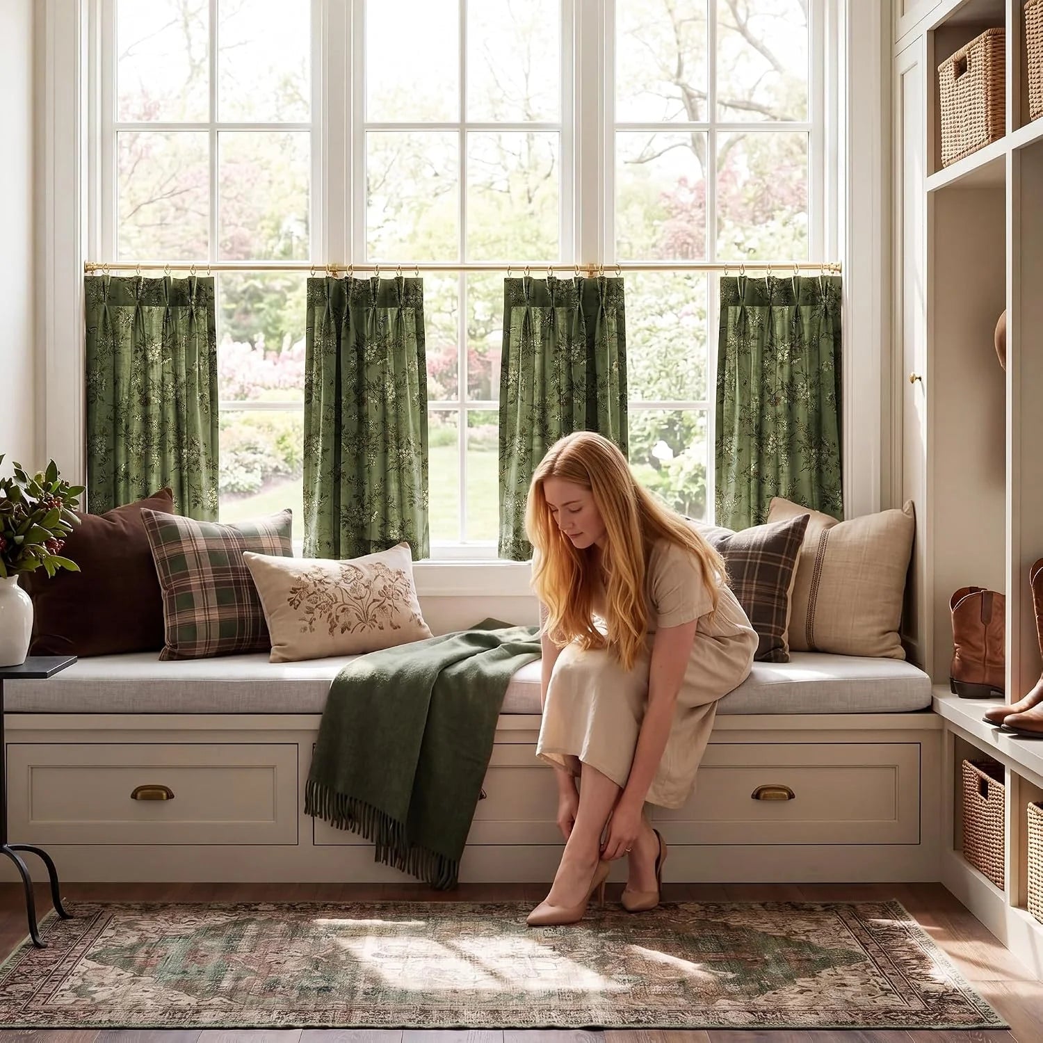 Sage green floral tier curtains above a cozy window seat in a bright farmhouse nook