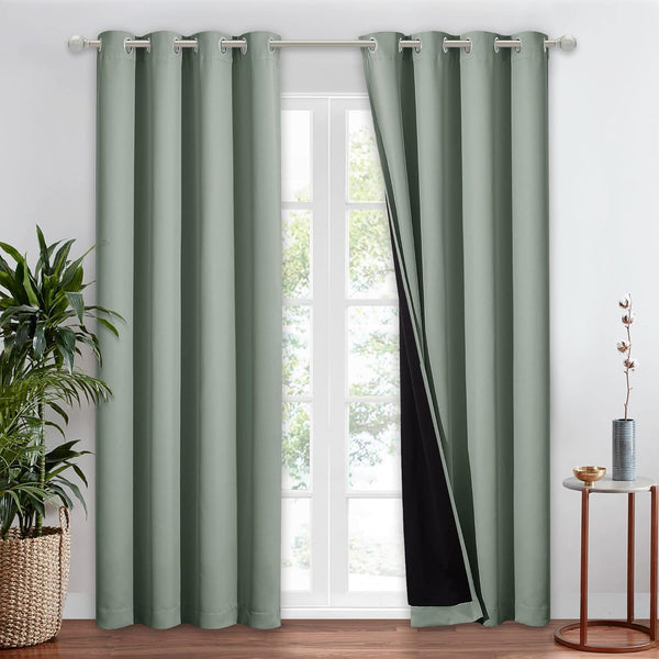 Green grommet top blackout curtains, one panel slightly open showing dark lining, in a modern room.