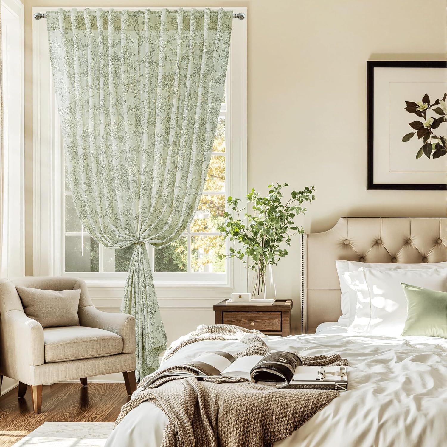Elegant sage green sheer curtain with subtle floral pattern, tied back gracefully in sunlit bedroom window.