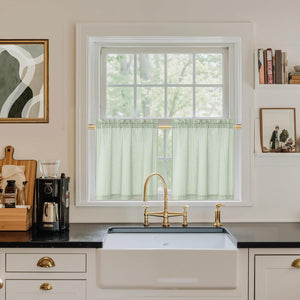 Sage green checkered cafe curtains with a rod pocket top in a bright kitchen window.