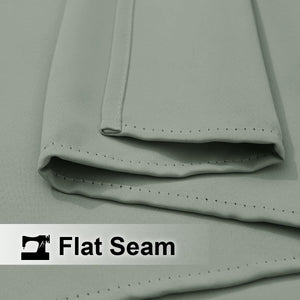 Light sage green fabric with a prominent flat seam, detailed with small, consistent dark stitching.