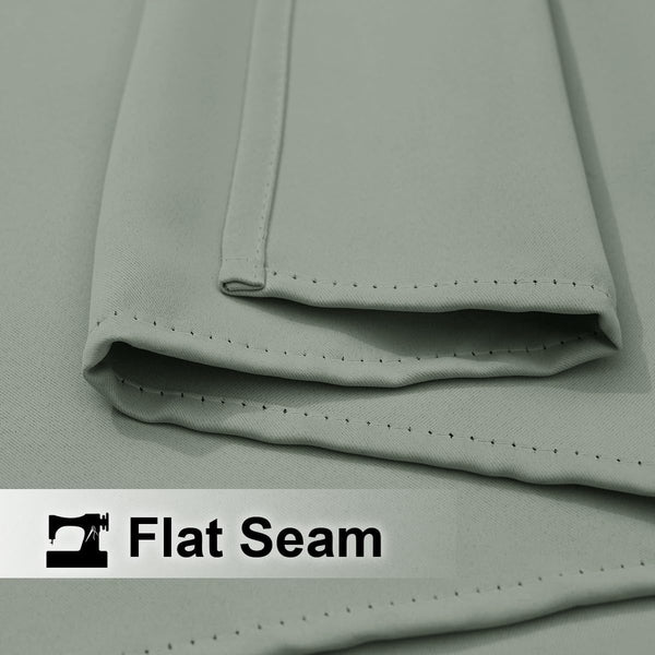 Light sage green fabric with a prominent flat seam, detailed with small, consistent dark stitching.