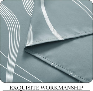 Sage green fabric close-up with white geometric curved lines and neat, detailed hem stitching.