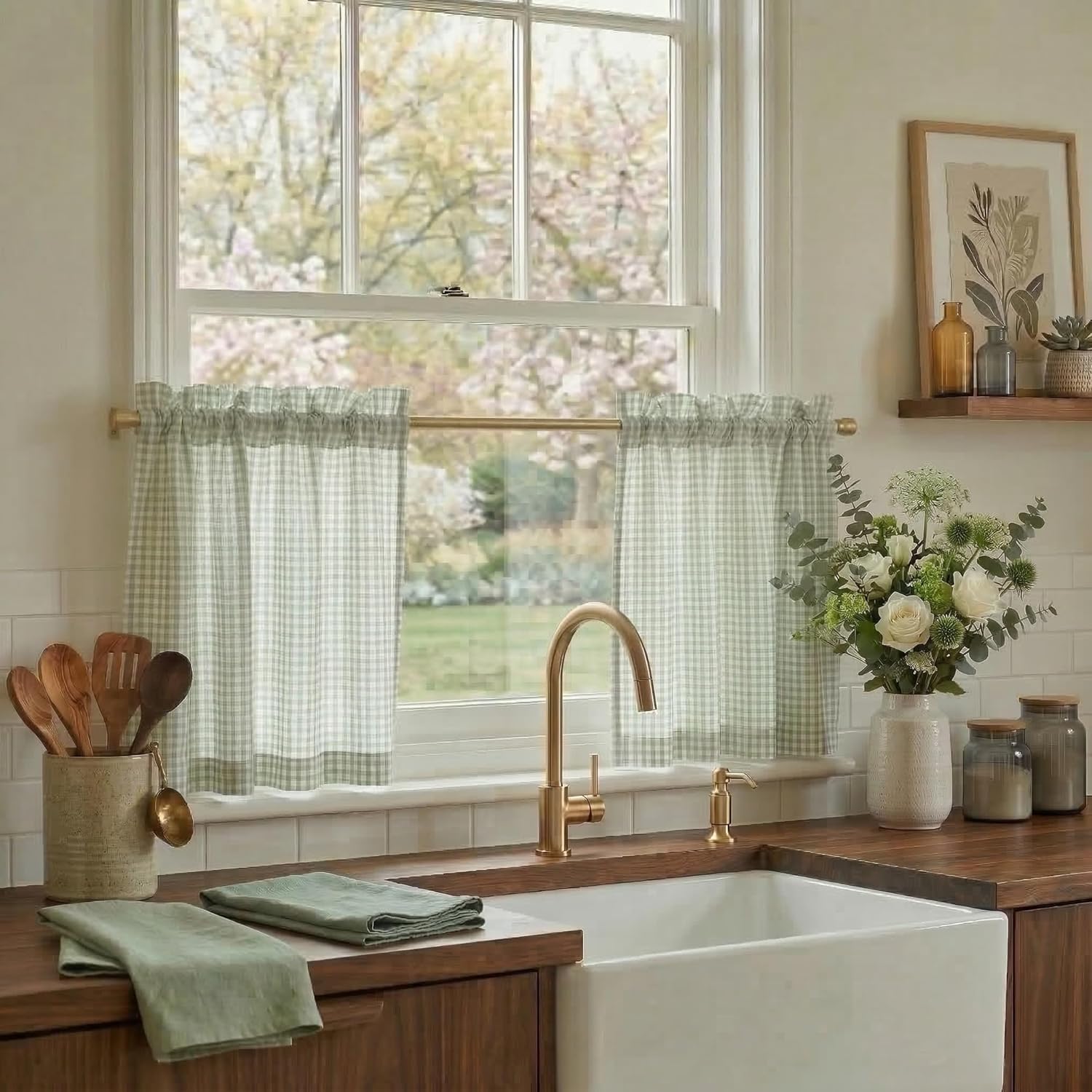 Sage green and white gingham ruffled cafe curtains over a farmhouse kitchen window with brass faucet.