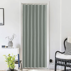 Solid sage green grommet top door curtain for privacy, hanging in a minimalist white interior doorway.