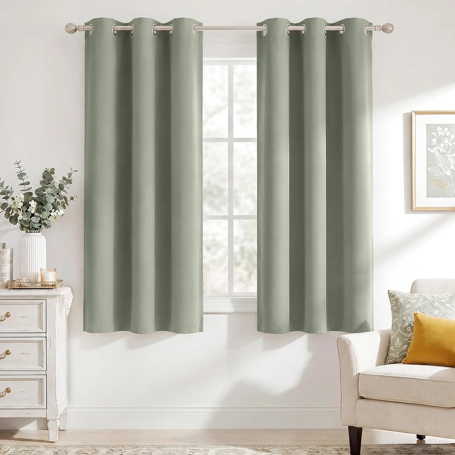 Pair of sage green grommet-top window curtains in a bright living room.