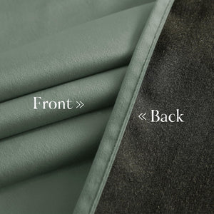 View of a sage green curtain fabric, highlighting its soft front and dark gray thermal lining back.